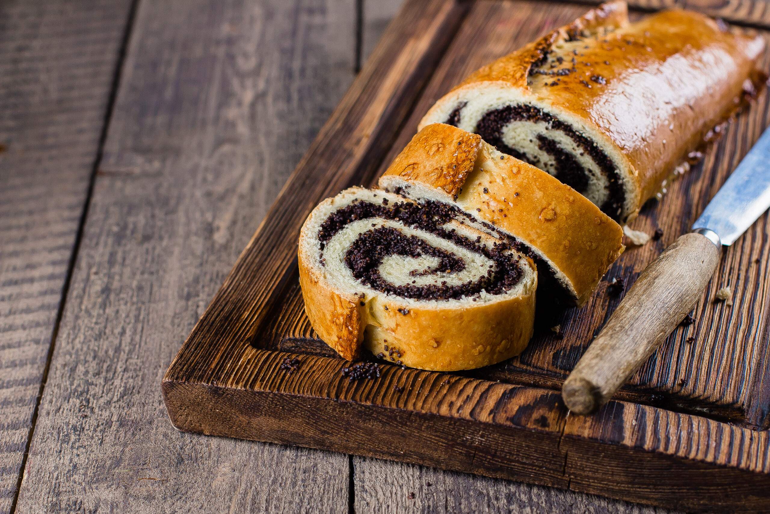 Homemade,Roll,With,Poppy,Seeds,On,Wooden,Board,On,Wooden