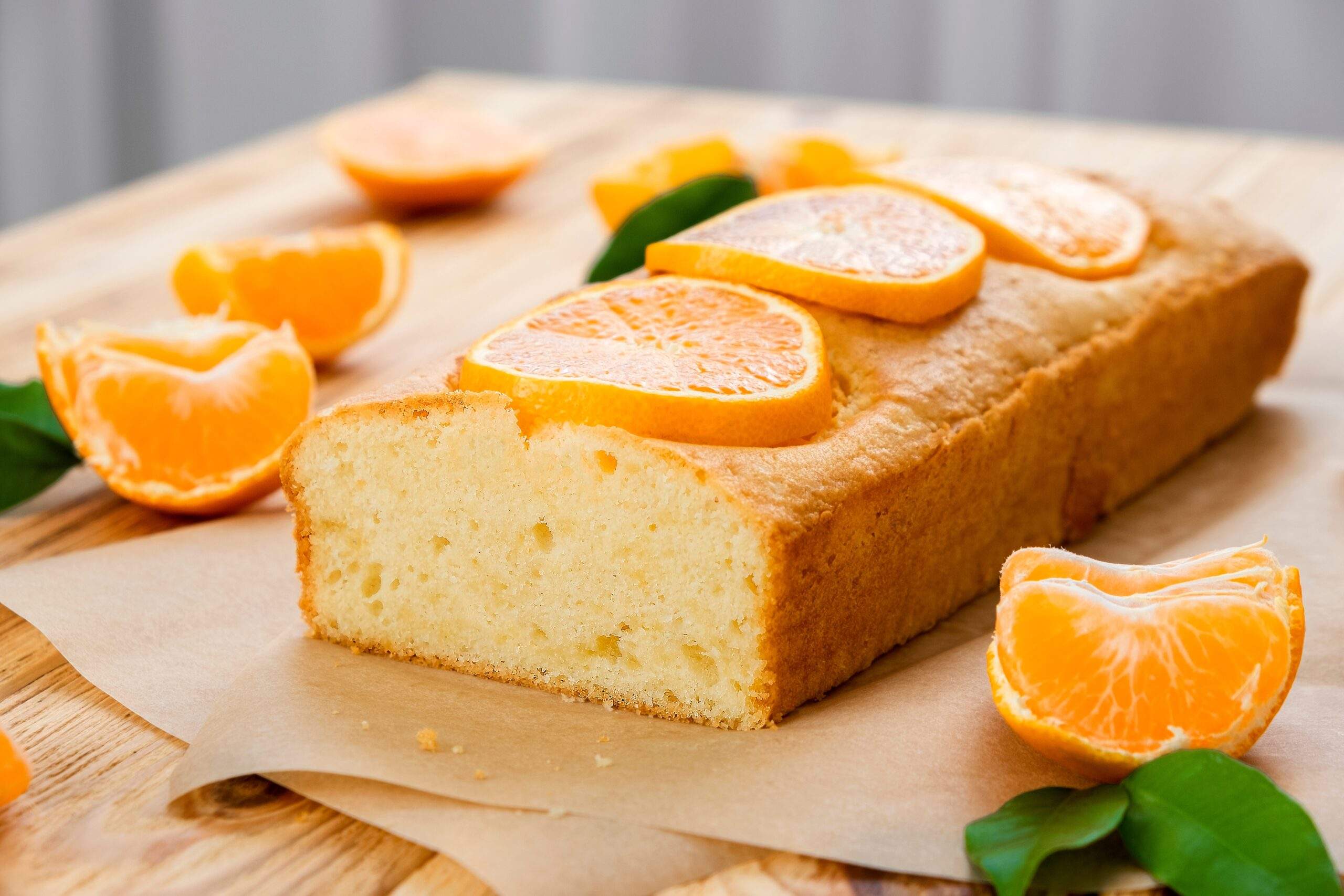 Loaf,Of,Delicious,Tangerine,Pound,Cake,On,Parchment,With,Pieces