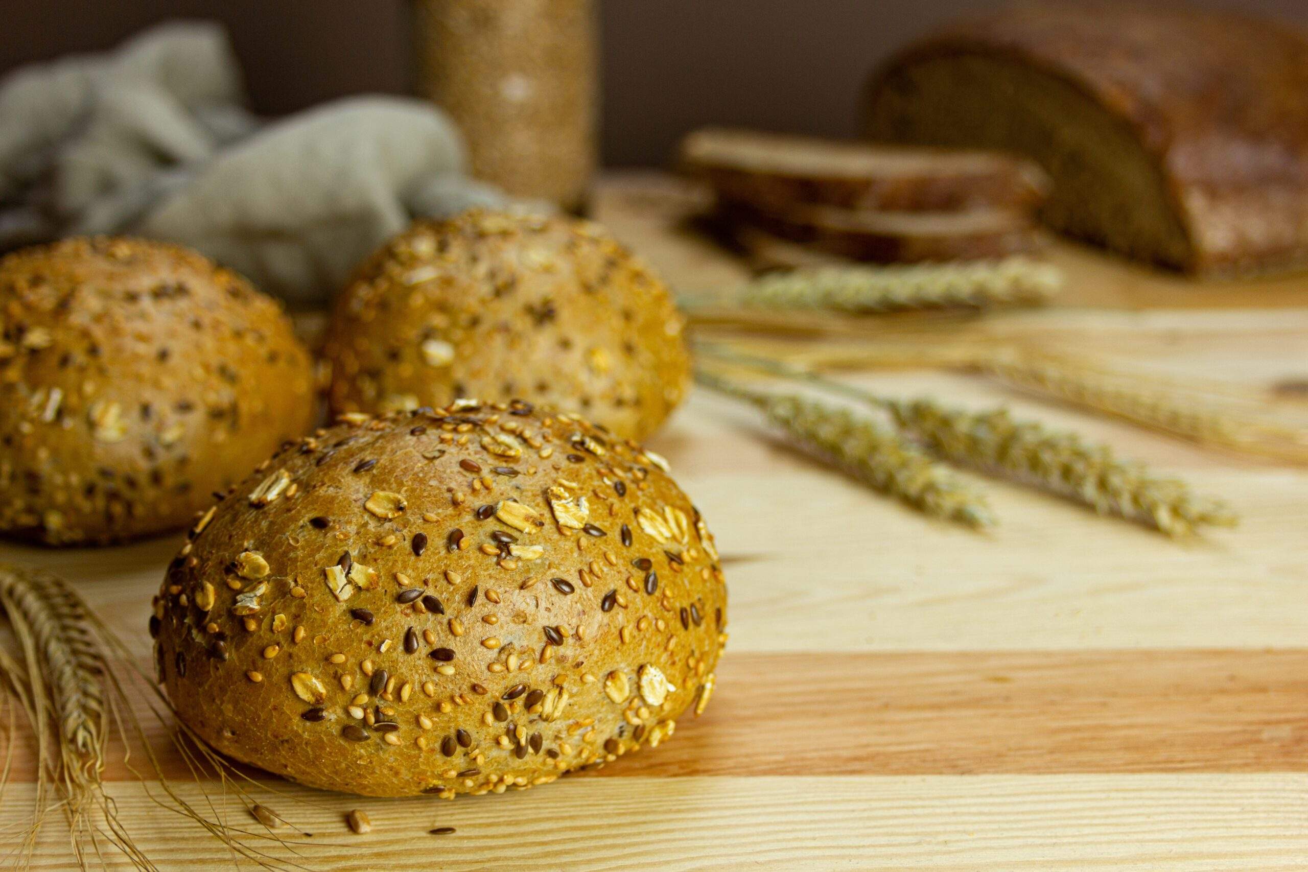 Three,Freshly,Baked,Round,Wholemeal,Buns,,German,Bread,,Loaf,And