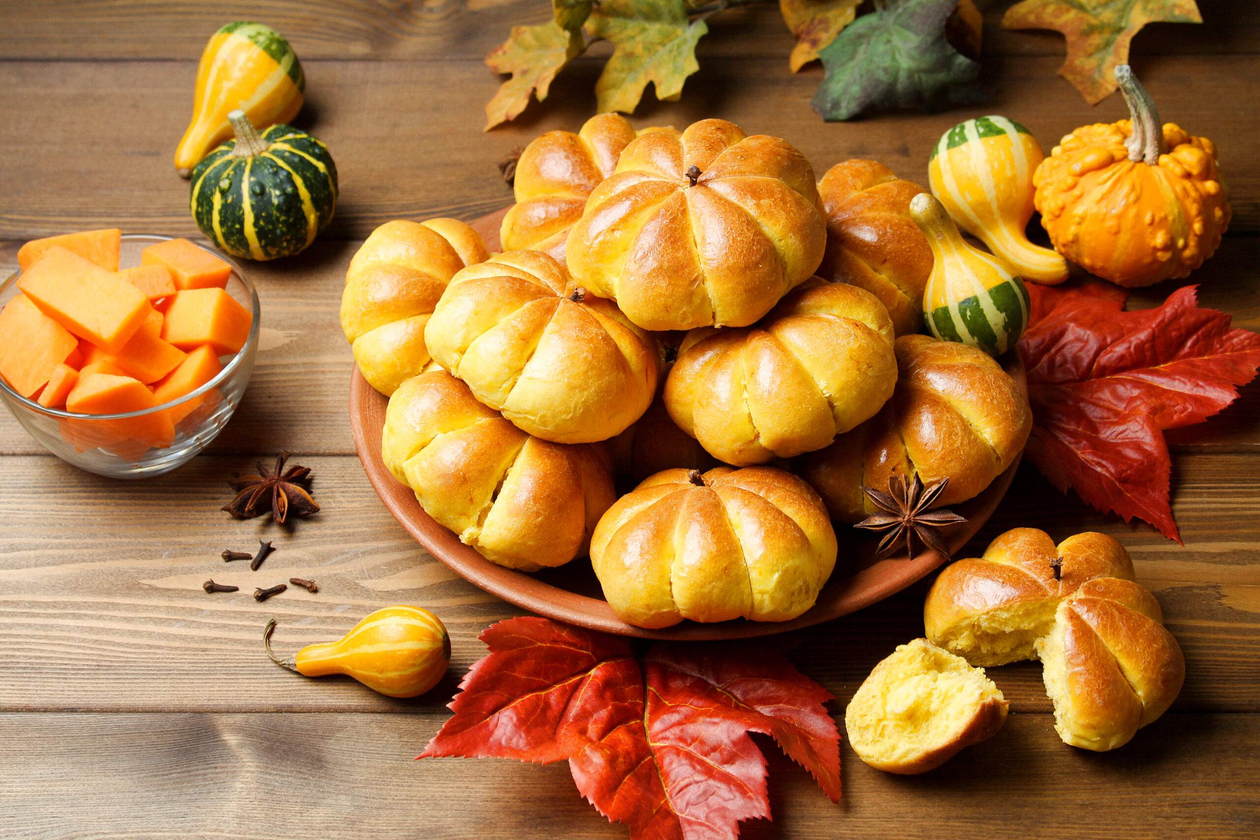 Pumpkin,Buns,On,Clay,Plate,And,Ingredients,Around,On,Wooden