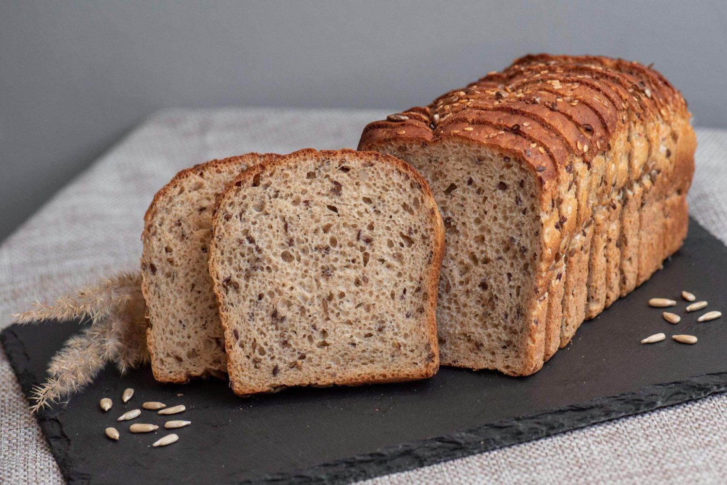 Rye,Bread,With,Seeds,Lies,On,A,Dark,Board,On