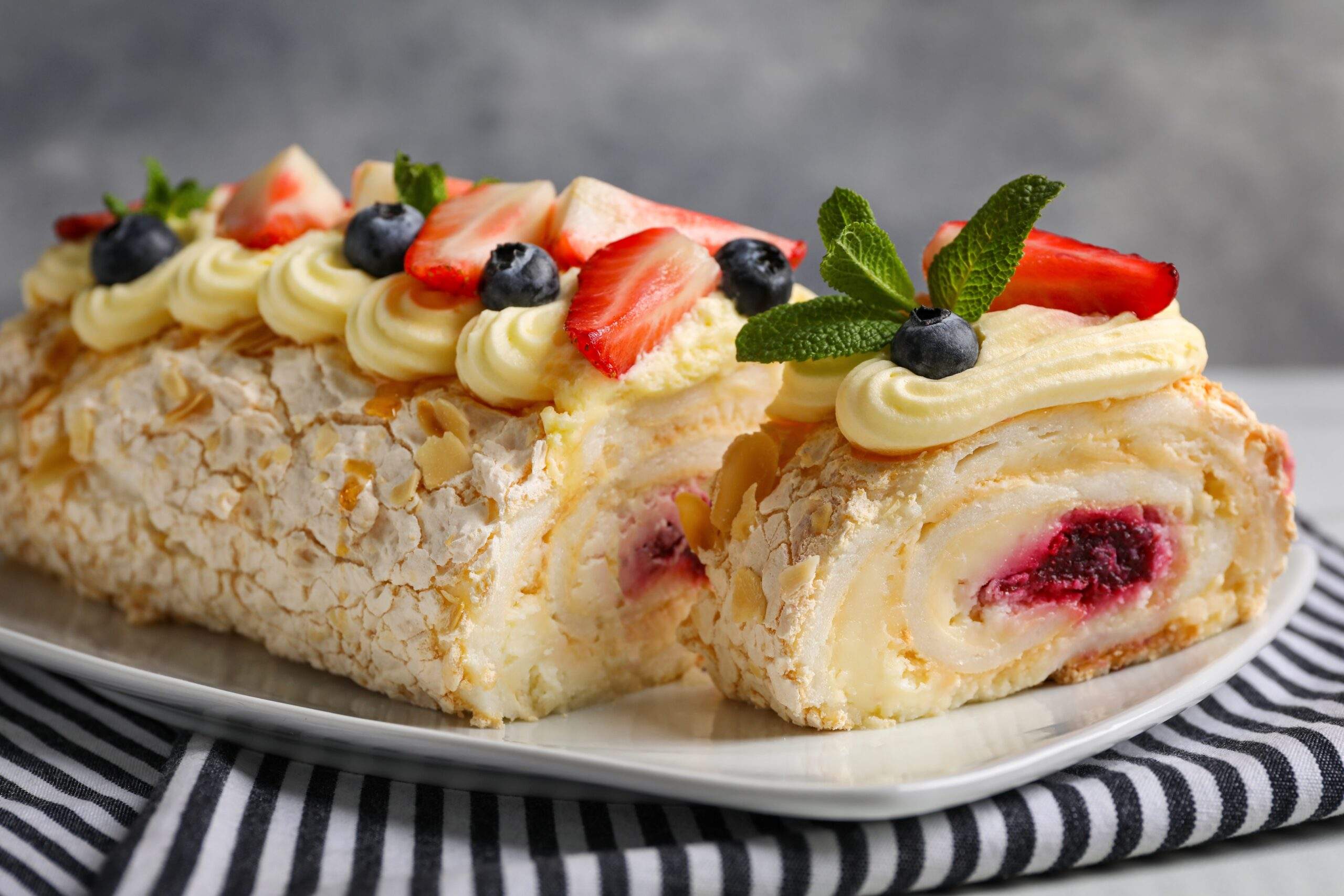 Tasty,Meringue,Roll,With,Jam,,Cream,,Strawberry,,Blueberry,And,Mint